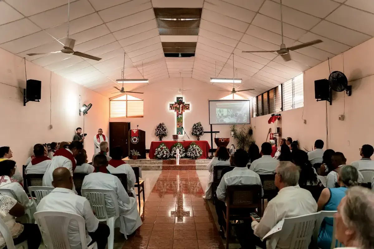 People talking together in the bright church lobby after a service